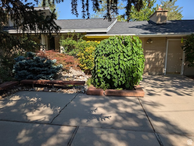 7481 S Castle Hill Cir, Cottonwood Heights, UT 84121 - view of front of property featuring a chimney and a patio area