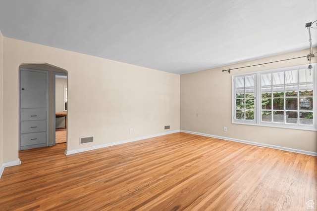3245 S 1000 E, Millcreek, UT 84106 - unfurnished room featuring light wood-style floors and arched walkways