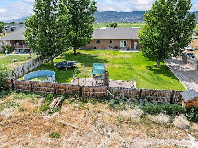 80 N 200 W, Central Valley, UT 84754 - fenced backyard with a trampoline and a mountain view