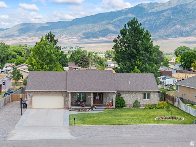 80 N 200 W, Central Valley, UT 84754 - view of front of home with a garage, a mountain view, driveway, and brick siding