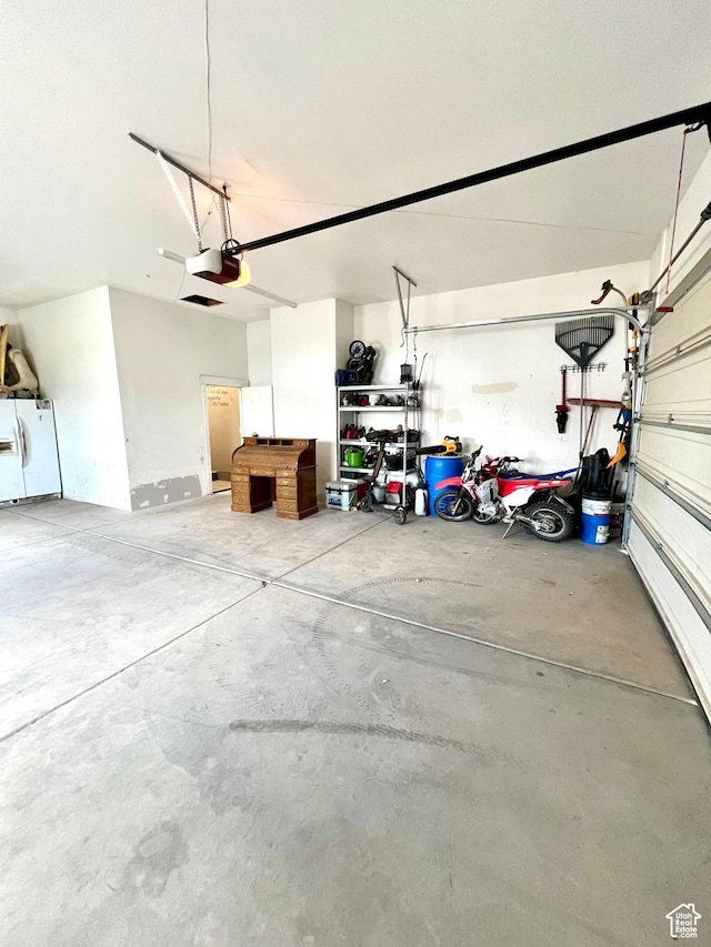 80 N 200 W, Central Valley, UT 84754 - garage with a garage door opener and white refrigerator with ice dispenser