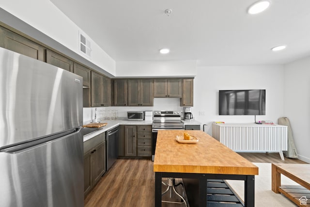 443 Kane Creek Blvd Unit 212, Moab, UT 84532 - kitchen featuring appliances with stainless steel finishes, dark wood finished floors, light countertops, dark brown cabinetry, and recessed lighting