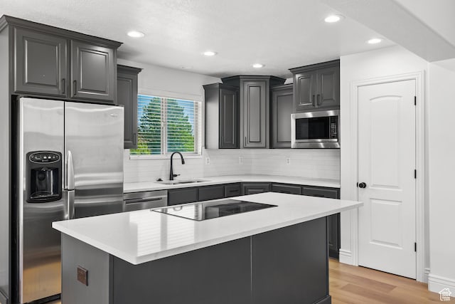 713 S 600 E, Layton, UT 84041 - kitchen featuring stainless steel appliances, tasteful backsplash, light wood-style floors, recessed lighting, and a center island