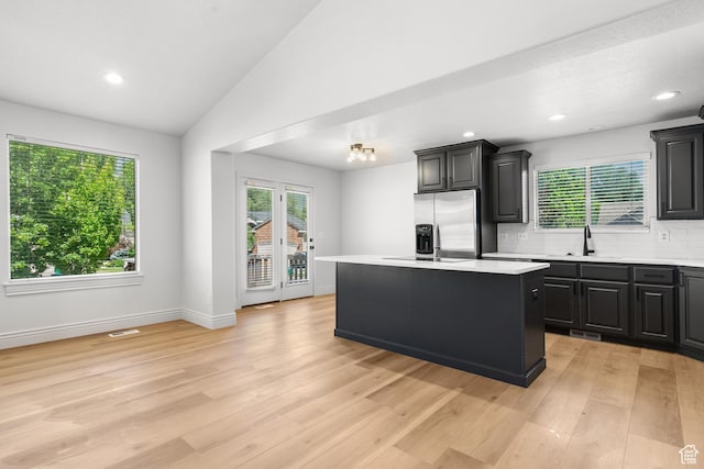 713 S 600 E, Layton, UT 84041 - kitchen featuring light countertops, a kitchen island, stainless steel fridge, tasteful backsplash, and light wood-style floors