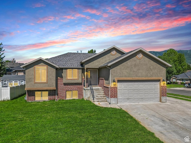 713 S 600 E, Layton, UT 84041 - view of front facade with driveway, stucco siding, an attached garage, and brick siding