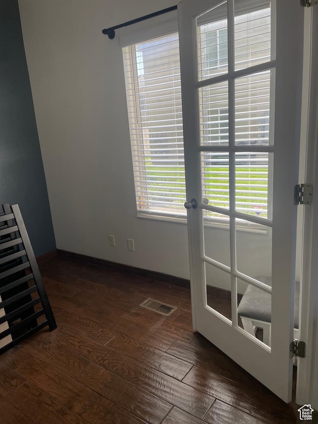 444 E Mitchell Cv Unit 103, South Salt Lake, UT 84115 - spare room featuring dark wood-style flooring, french doors, and healthy amount of natural light