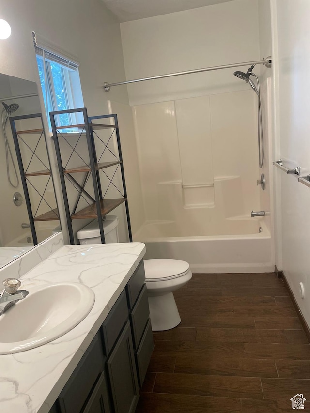 444 E Mitchell Cv Unit 103, South Salt Lake, UT 84115 - full bathroom with vanity, wood finished floors, and washtub / shower combination