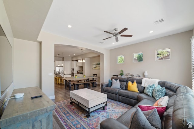 2076 N Doral Ct, Washington, UT 84780 - living room with a ceiling fan, wood finished floors, arched walkways, recessed lighting, and a chandelier