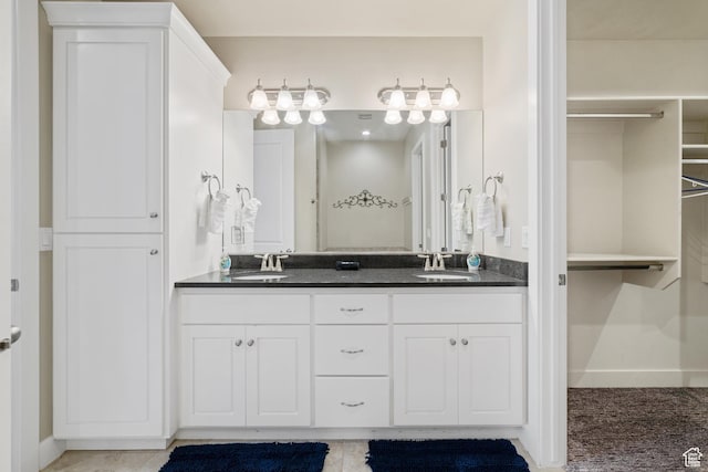 2076 N Doral Ct, Washington, UT 84780 - bathroom with double vanity and a walk in closet