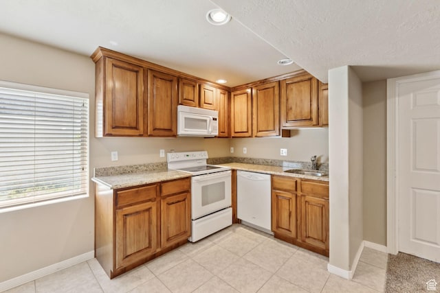 562 E 260 S, Midway, UT 84049 - kitchen featuring white appliances, brown cabinets, recessed lighting, light tile patterned flooring, and a textured ceiling