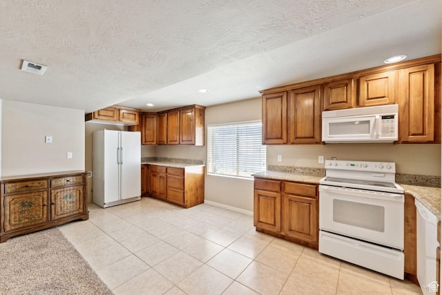 562 E 260 S, Midway, UT 84049 - kitchen with white appliances, brown cabinetry, recessed lighting, a textured ceiling, and light tile patterned floors