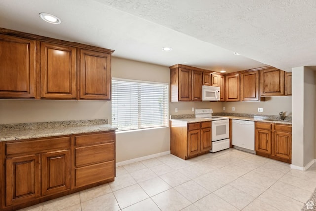 562 E 260 S, Midway, UT 84049 - kitchen with white appliances, brown cabinets, recessed lighting, light tile patterned floors, and light stone counters