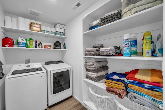 3217 E Elkhorn Ln, Washington, UT 84780 - washroom featuring washing machine and clothes dryer and wood finished floors