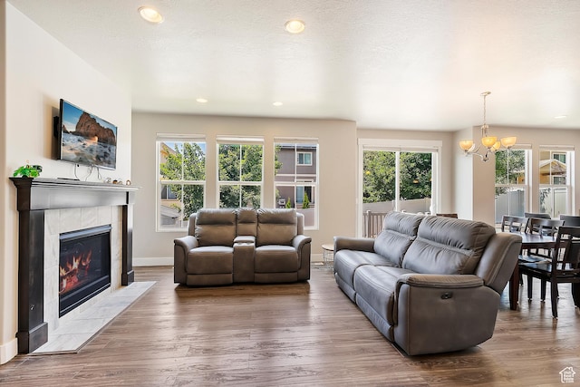 3359 N Redshoulder Dr, Layton, UT 84040 - living area featuring healthy amount of natural light, a chandelier, wood finished floors, a fireplace, and recessed lighting
