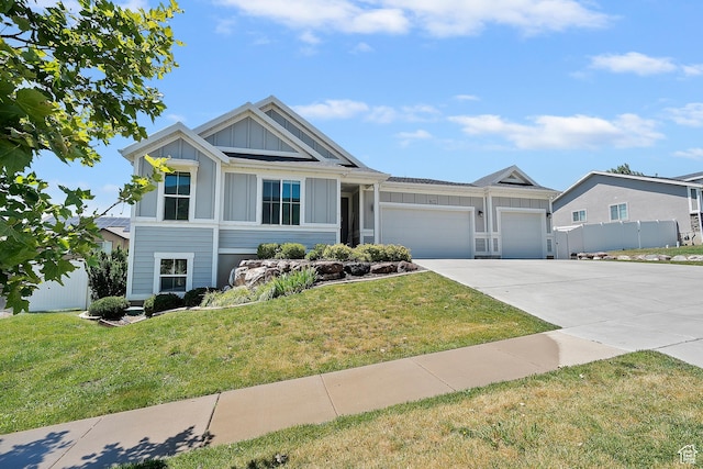 3359 N Redshoulder Dr, Layton, UT 84040 - view of front of property with board and batten siding, driveway, a garage, and a front yard