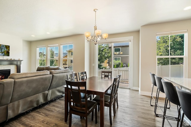 3359 N Redshoulder Dr, Layton, UT 84040 - dining space featuring a chandelier, dark wood-type flooring, healthy amount of natural light, a fireplace, and recessed lighting