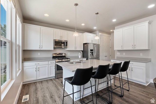 3359 N Redshoulder Dr, Layton, UT 84040 - kitchen featuring appliances with stainless steel finishes, healthy amount of natural light, wood finished floors, and recessed lighting