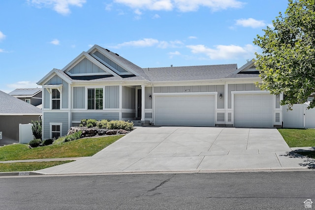 3359 N Redshoulder Dr, Layton, UT 84040 - view of front of property featuring board and batten siding, an attached garage, concrete driveway, and roof with shingles