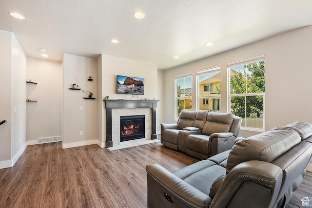 3359 N Redshoulder Dr, Layton, UT 84040 - living room featuring wood finished floors, a tiled fireplace, and recessed lighting