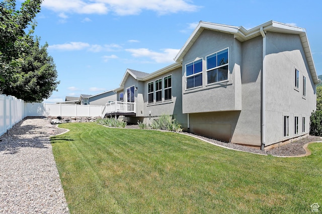 3359 N Redshoulder Dr, Layton, UT 84040 - back of house featuring stucco siding, a fenced backyard, and a wooden deck