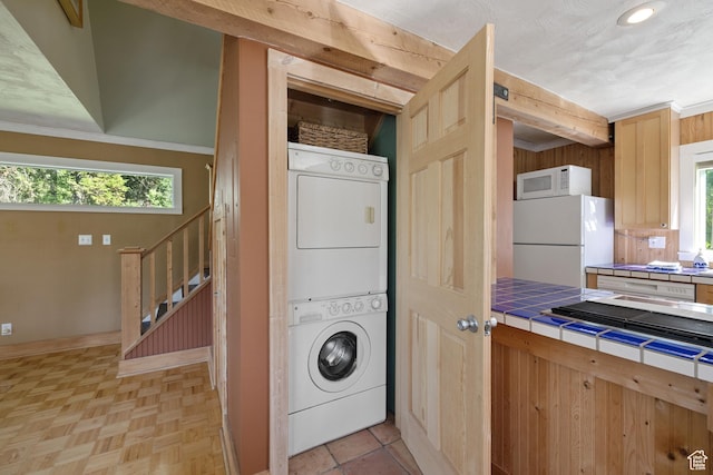 1519 Pine Needle Cir, Coalville, UT 84017 - washroom featuring stacked washing machine and dryer, healthy amount of natural light, and recessed lighting