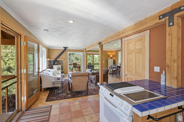 1519 Pine Needle Cir, Coalville, UT 84017 - kitchen with tile countertops, ornamental molding, white range with electric stovetop, open floor plan, and recessed lighting