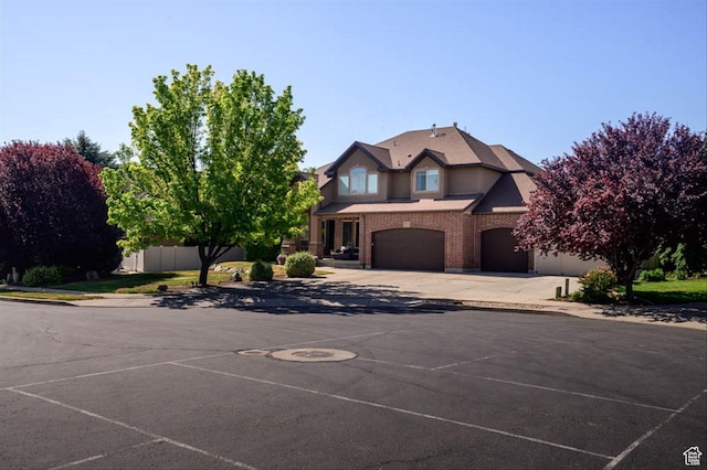 3371 W Waterbridge Cv Unit 417, South Jordan, UT 84095 - view of front of house with a garage, concrete driveway, and brick siding