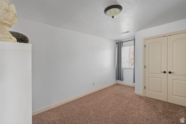 3371 W Waterbridge Cv Unit 417, South Jordan, UT 84095 - unfurnished bedroom with carpet floors, a closet, and a textured ceiling