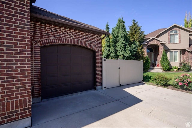 3371 W Waterbridge Cv Unit 417, South Jordan, UT 84095 - garage featuring driveway and a gate