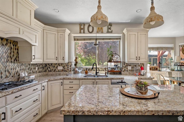 3371 W Waterbridge Cv Unit 417, South Jordan, UT 84095 - kitchen featuring healthy amount of natural light, light stone counters, backsplash, and recessed lighting
