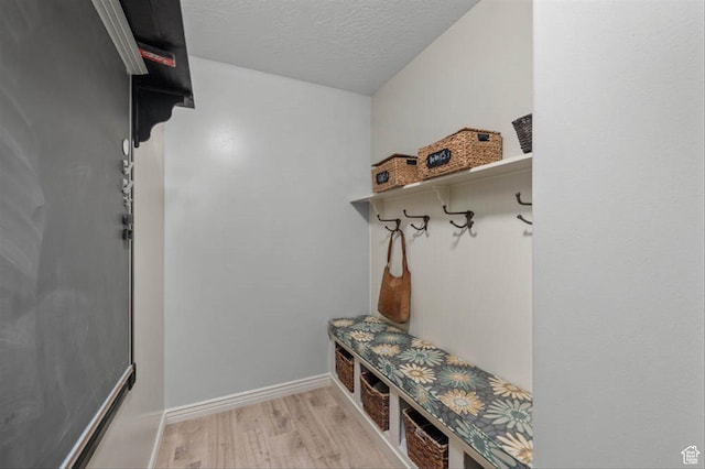 3371 W Waterbridge Cv Unit 417, South Jordan, UT 84095 - mudroom featuring light wood-type flooring and a textured ceiling