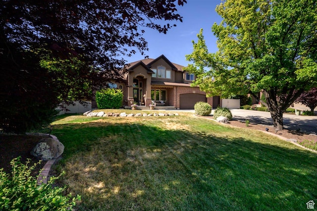 3371 W Waterbridge Cv Unit 417, South Jordan, UT 84095 - traditional-style home with an attached garage, driveway, a front lawn, and brick siding