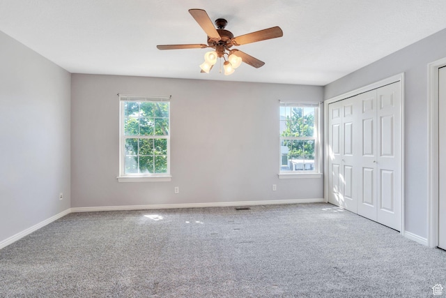 303 E 900 S Unit 42, Payson, UT 84651 - unfurnished bedroom featuring multiple windows, carpet floors, and ceiling fan