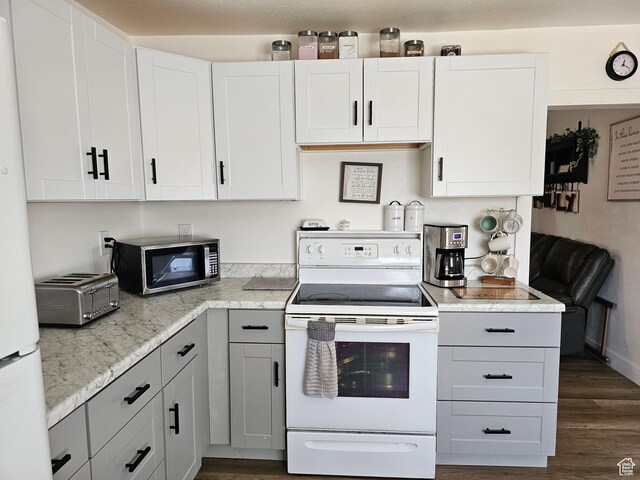 92 W 300 N, Huntington, UT 84528 - kitchen featuring white appliances, dark wood-style floors, white cabinets, and light stone countertops