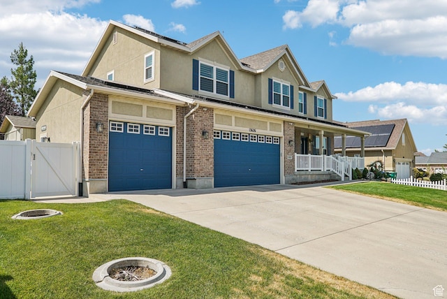 13626 S Bluewing Way, Riverton, UT 84096 - view of front facade featuring a porch, concrete driveway, stucco siding, an attached garage, and a gate