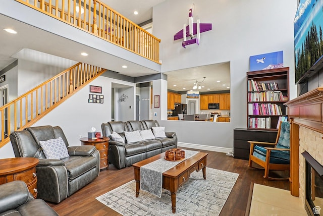 13626 S Bluewing Way, Riverton, UT 84096 - living room with a high ceiling, hardwood / wood-style floors, recessed lighting, stairway, and a fireplace with flush hearth
