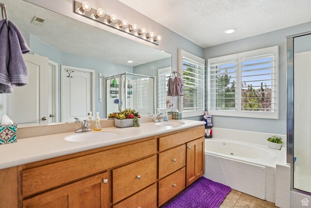 13626 S Bluewing Way, Riverton, UT 84096 - full bathroom featuring a shower stall, double vanity, a jetted tub, a textured ceiling, and tile patterned floors