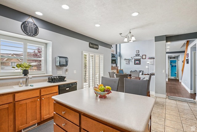13626 S Bluewing Way, Riverton, UT 84096 - kitchen with dishwasher, light countertops, brown cabinets, healthy amount of natural light, and recessed lighting