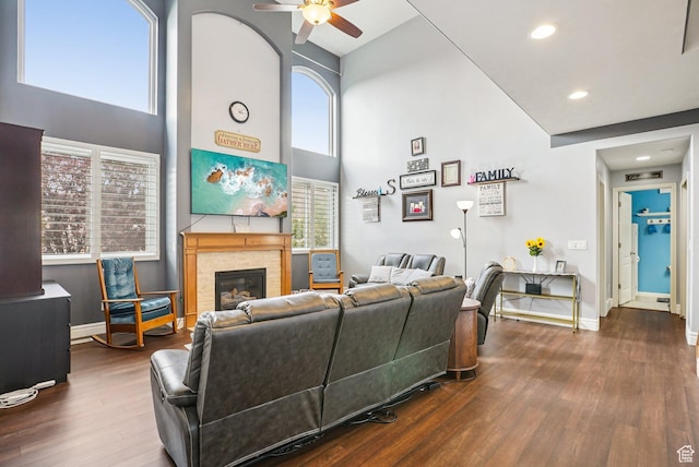 13626 S Bluewing Way, Riverton, UT 84096 - living area with a towering ceiling, wood finished floors, ceiling fan, a glass covered fireplace, and recessed lighting
