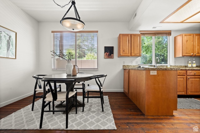 1600 W Pinebrook Blvd Unit F3, Park City, UT 84098 - kitchen featuring dark wood-style floors, plenty of natural light, decorative light fixtures, and brown cabinets