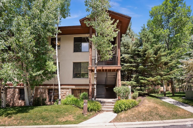 1600 W Pinebrook Blvd Unit F3, Park City, UT 84098 - view of front of home featuring stucco siding, stone siding, a front yard, and stairs