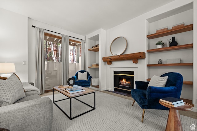 1600 W Pinebrook Blvd Unit F3, Park City, UT 84098 - living room featuring built in features, a fireplace with flush hearth, and wood finished floors