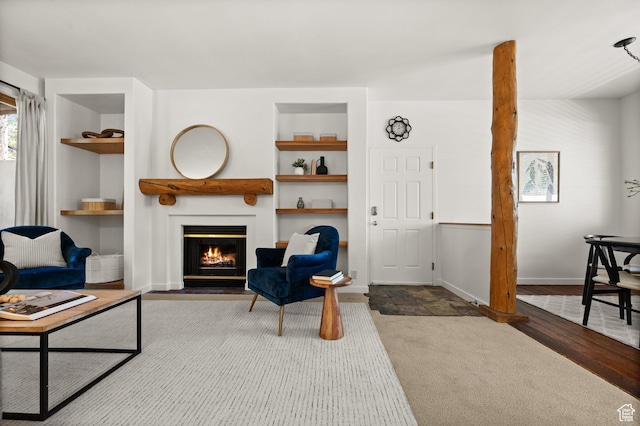 1600 W Pinebrook Blvd Unit F3, Park City, UT 84098 - living room featuring built in shelves, a fireplace with flush hearth, and carpet