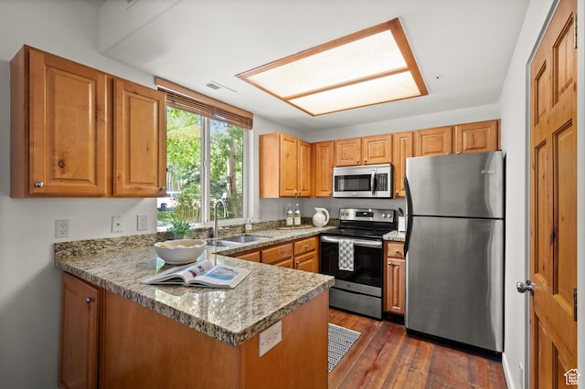 1600 W Pinebrook Blvd Unit F3, Park City, UT 84098 - kitchen featuring appliances with stainless steel finishes, a peninsula, dark wood-style floors, and brown cabinetry