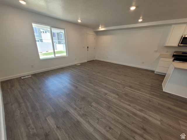 1596 S 3740 E Unit 1358, Spanish Fork, UT 84660 - unfurnished living room featuring dark wood-style floors, recessed lighting, and a textured ceiling