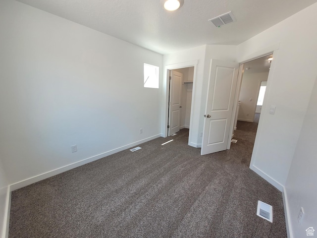 1596 S 3740 E Unit 1358, Spanish Fork, UT 84660 - unfurnished bedroom featuring dark colored carpet and a walk in closet