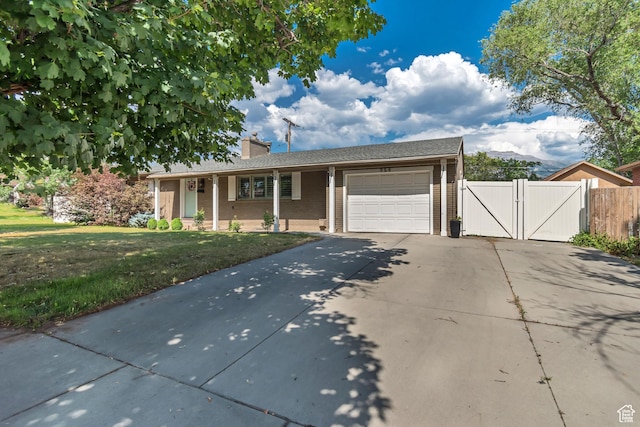 954 N 100 E, American Fork, UT 84003 - ranch-style home with concrete driveway, a garage, a gate, brick siding, and a chimney