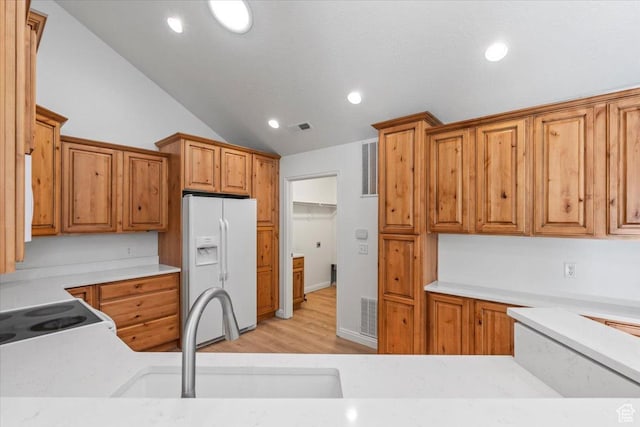 317 S 450 W Unit C, Springville, UT 84663 - kitchen featuring white appliances, light countertops, vaulted ceiling, light wood-style floors, and brown cabinets
