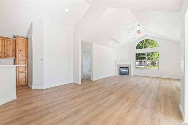 317 S 450 W Unit C, Springville, UT 84663 - unfurnished living room featuring vaulted ceiling, a ceiling fan, light wood-style floors, and a tiled fireplace