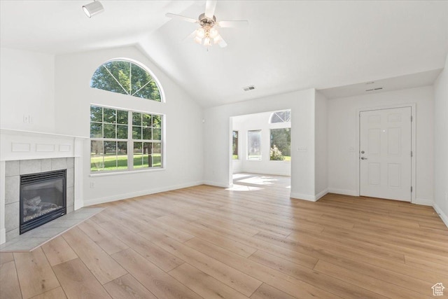 317 S 450 W Unit C, Springville, UT 84663 - unfurnished living room featuring ceiling fan, a tiled fireplace, light wood-style flooring, and high vaulted ceiling